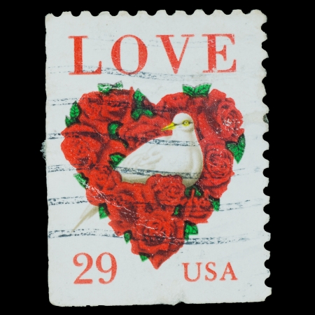 USA - CIRCA 1994  A stamp printed in USA shows word  love  and dove in a love heart made of roses, circa 1994のeditorial素材