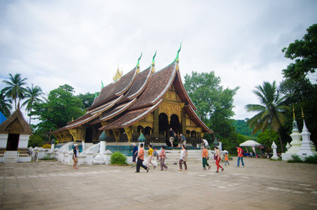 LUANG PRABANG, LAOS - AUGUST 11 :  Visitors tour the Wat Xieng Thong on August 11, 2014 in Luang Prabang, Laos.Wat Xieng Thong, the oldest and most beautiful temples in Luang Prabangのeditorial素材