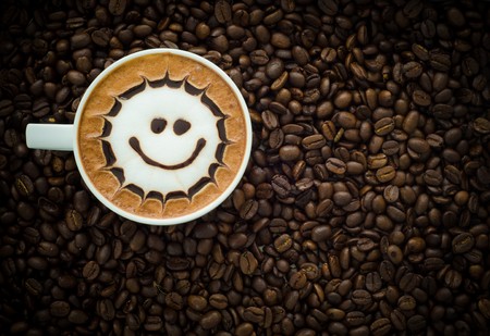 Closeup of a beautiful cup of hot coffee on coffee bean backgroundの写真素材