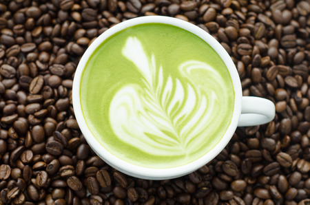 Closeup of a beautiful green tea on coffee bean background