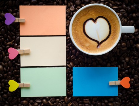 A cup of latte art coffee and clip noteの写真素材