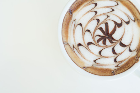 a cup of latte art on white backgroundの写真素材