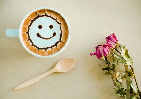 a cup of latte art on brown paper backgroundの写真素材