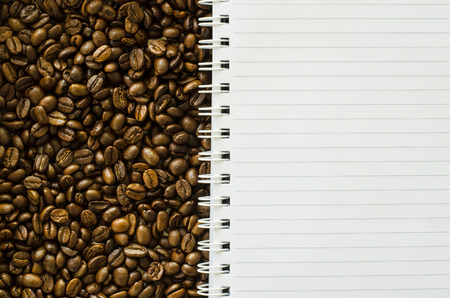 Notebook on coffee bean backgroundの写真素材