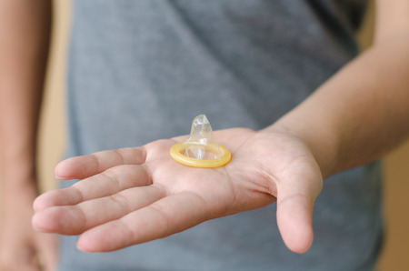 hand holding condomの写真素材