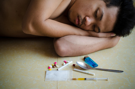 drug addict laying on the floorの写真素材