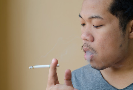 young man smoking a cigaretteの写真素材