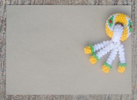 garland knitting and brown paper on cement backgroundの写真素材