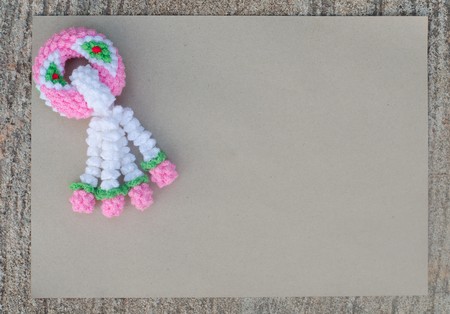 garland knitting and brown paper on cement backgroundの写真素材