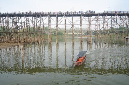 SANGKLABURI THAILAND  MAY 3 2015 : Traveler crossing wooden bridge or Mon Bridge in Sangklaburi. Kanchanaburi Thailand. Attractions traditional way of lifeのeditorial素材
