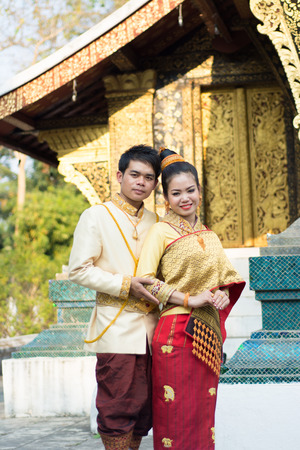 Luang Prabang, Laos February 17, 2014 : Unidentified young boy and young girl in Laos national costume at wat xieng thong , They take a photo before marryのeditorial素材
