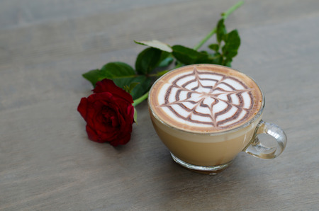 hot latte art coffee on wooden tableの写真素材