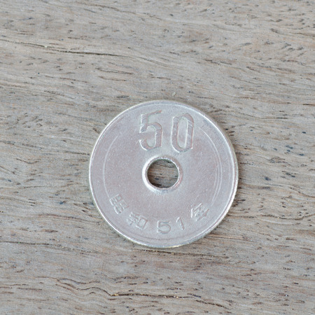 Japanese coins on wooden background