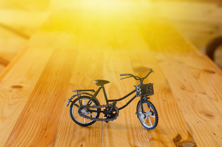 Small  toy, bicycle model on wooden backgroundの写真素材