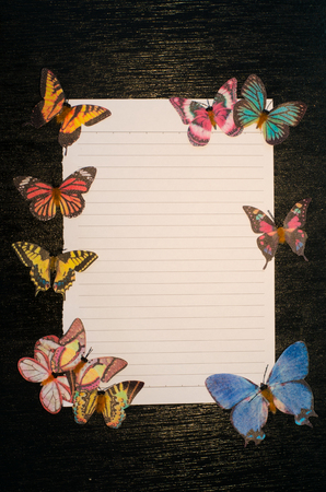 Butterfly decoration on the black wooden background, still life butterflyの写真素材