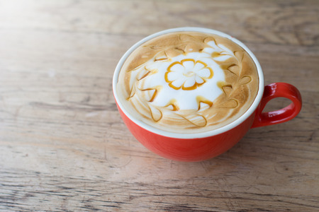 Cup of latte art coffee on wooden backgroundの写真素材