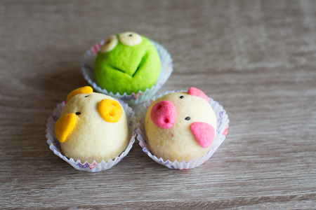 Fancy cookies on wooden table, frog and pigs cookiesの写真素材
