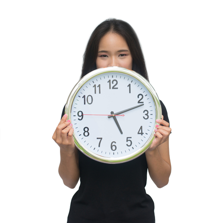 Beautiful asian young woman holding a clock isolated on white background