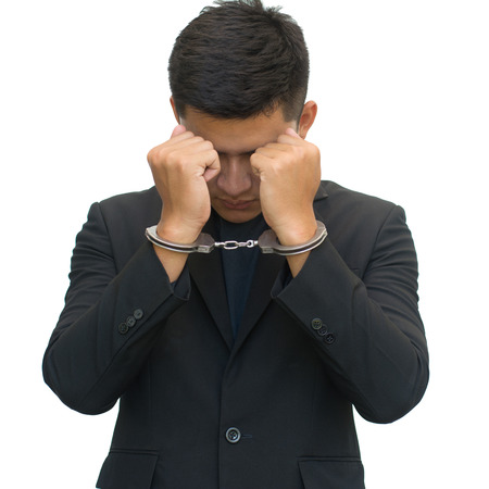 Businessman with handcuffs isolated on white background with clipping path.Corruption concept.の写真素材