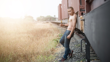 Asian shirtless male model at railroadの写真素材