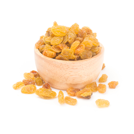 organic dried raisins in a wooden bowl isolated on white backgroundの写真素材
