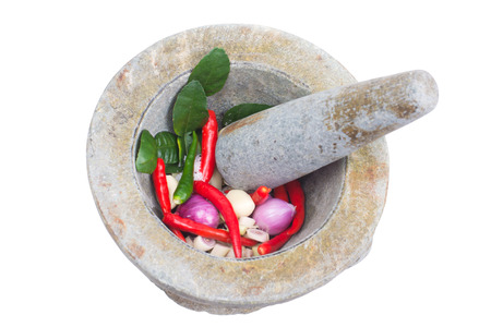 Thai ingredient for spicy paste with garlic, onion, chili, side of granite mortar and pestle on wooden table. With clipping pathの写真素材
