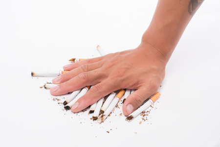 hand of man holds a cigarette in his hand. In order to stop smoke cigarettes is addictive. Health Concepts and Non-Smoking Dayの写真素材