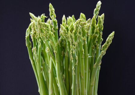 Fresh green asparagus isolated on black backgroundの写真素材
