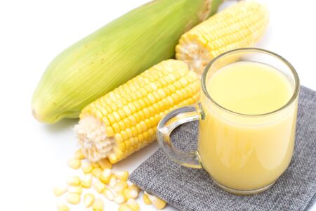 Fresh sweet corn juice (corn milk) and corn isolated on white background.の写真素材