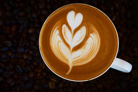 Cup of latte art on coffee bean backgroundの写真素材