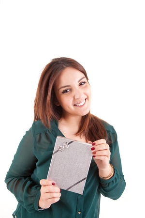 Beautiful woman holding presents while smiling over white backgroundの写真素材