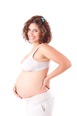 Beautiful pregnant woman showing her good shape over white backgroundの写真素材