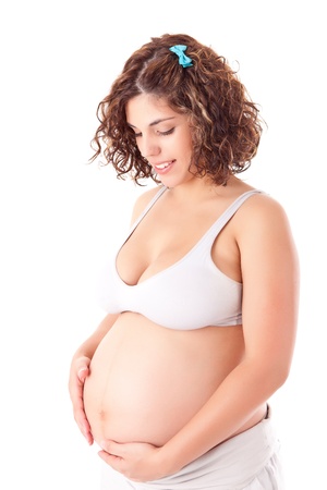 Beautiful pregnant woman showing her good shape over white backgroundの写真素材