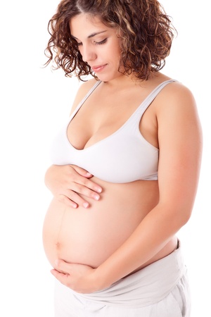 Beautiful pregnant woman showing her good shape over white backgroundの写真素材