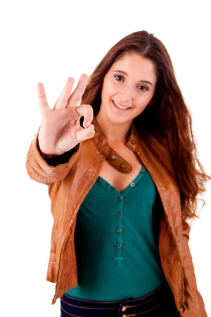 Beautiful young woman doing ok over white backgroundの写真素材