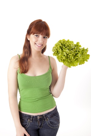 Beautiful woman with lettuce salad on white backgroundの写真素材