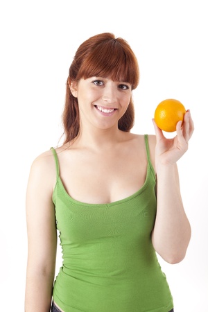 Beautiful woman with an orange fruit on white backgroundの写真素材
