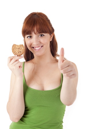Beautiful young woman eating diet biscuits on white backgroundの写真素材