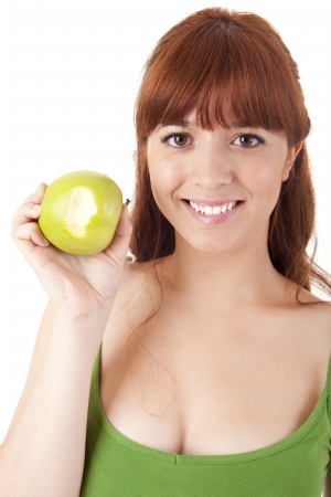Beautiful young woman eating apple on white backgroundの写真素材
