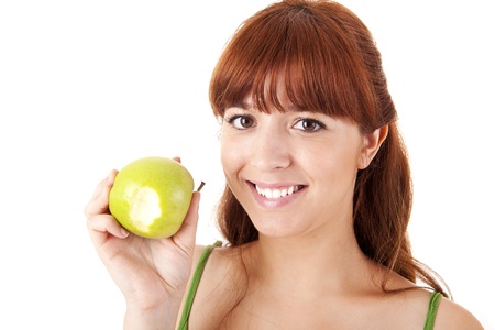 Beautiful young woman eating apple on white backgroundの写真素材