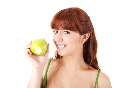 Beautiful young woman eating apple on white backgroundの写真素材