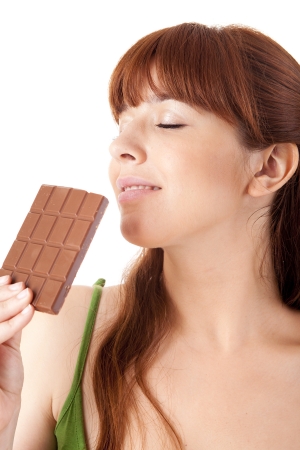 Beautiful young woman holding chocolate on white backgroundの写真素材