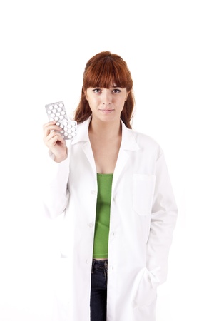 Young medic holding some pills on white backgroundの写真素材