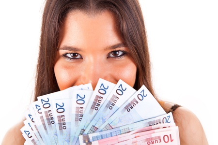 Portrait of a happy woman with a fan of Euros currency notesの写真素材