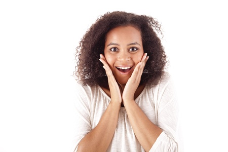 Surprised young african woman with hands over her mouthの写真素材