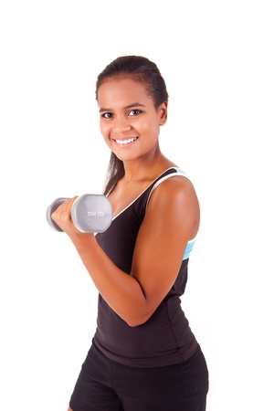 Beautiful african fitness woman working out with free weightsの写真素材