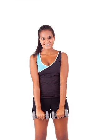 Beautiful african fitness woman working out with free weightsの写真素材