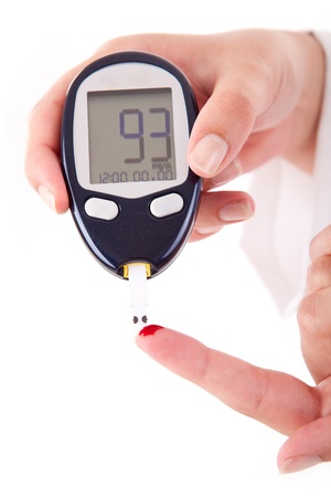 Diabetes patient measuring glucose level bloodの写真素材
