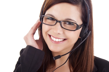 Portrait of a happy young call centre employee smiling with a headset over whiteの写真素材