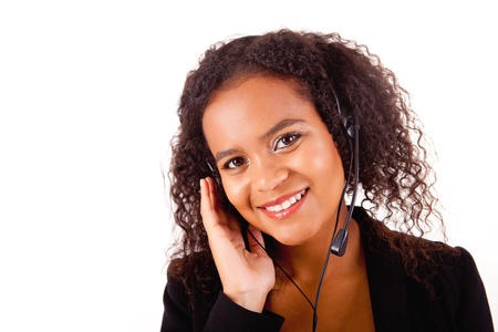 Beautiful african call center woman at work smiling with headset の写真素材
